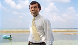 Image: Mohamed Nasheed standing on beach. Title: Mohamed Nasheed: Climate Champion for the World’s Most Vulnerable