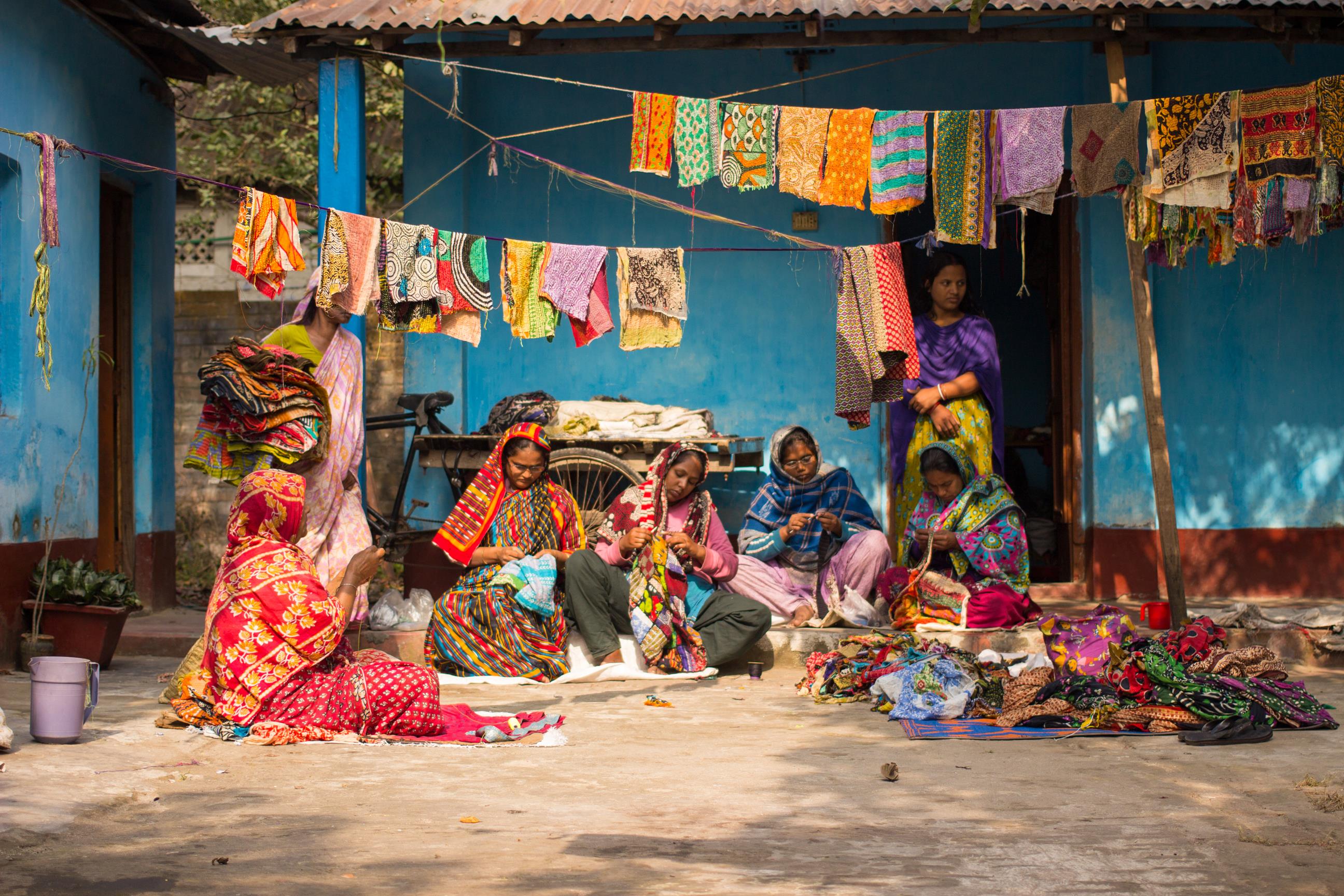 Women of the Hajiganj Group workshop in Bangladesh’s Nilphamari District making recycled sari wrap baskets. 