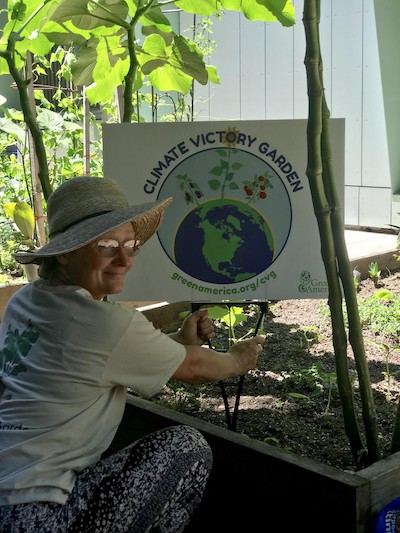 woman holding gardening sign