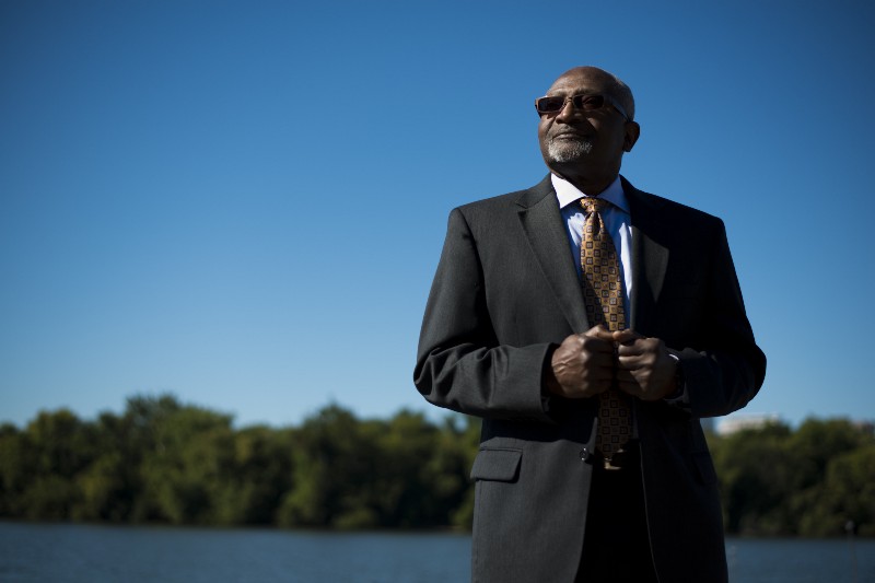 robert bullard, black man in suit standing against blue sky