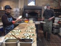 Fawziah Alshehri and Bob O’Neil make fresh, organic pizza in Village Bakery & Café’s kitchen