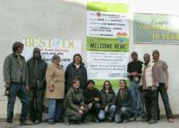 The Main Street Alliance is urging businesses nationwide to print out and display its anti-hate posters in their offices and shop-fronts. Community Forklift turned theirs into a huge banner, seen here hagning in front of their Maryland warehouse store with several employees. Photo courtesy of Community Forklift.