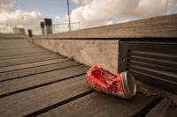 can of coke on sidewalk