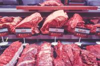 Image: rows of red meat in grocery case. Topic: Go Vegetarian: Eat Less Meat to Cool the Planet
