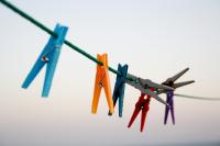 Image: clothespins on a line. Title: Going Green: Eco-Friendly Laundry Products