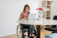 woman in wheelchair at table