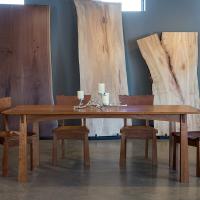 TY Fine Furniture table in front of wood slabs