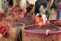 Image: workers dyeing textiles in large concrete vats. Topic: Toxic Textiles