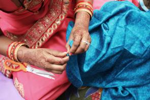 An artisan carefully handcrafts the Kantha Jewelry.