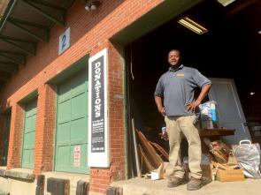 A Community Forklift staff member stands in the doorway of our donations bay.