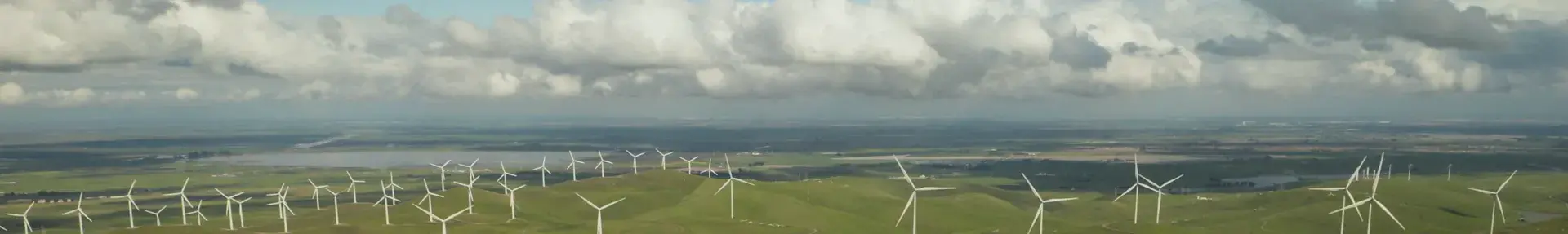Image: wind turbines on green hills. Title: Clean Energy Victory Bonds
