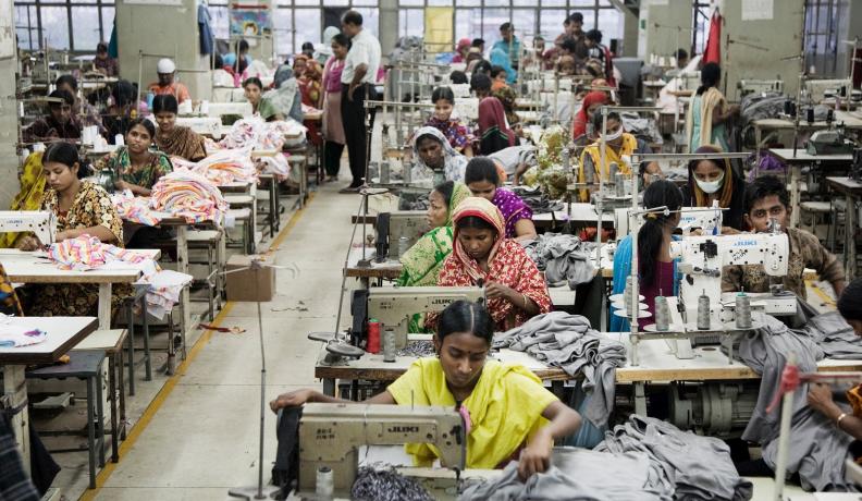 Image: factory garment workers in crowded room. Topic: Unpacking Toxic Textiles