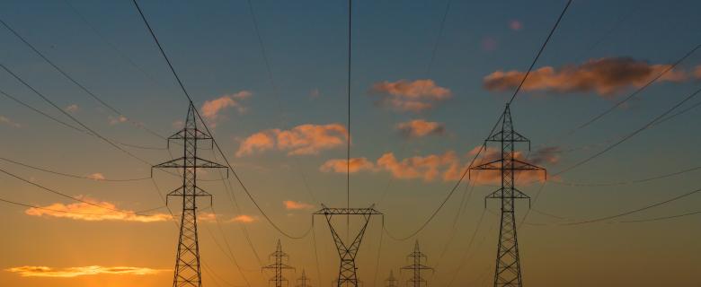 Sunset behind power lines and towers