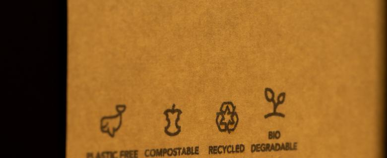 A compostable cardboard box with various certifications