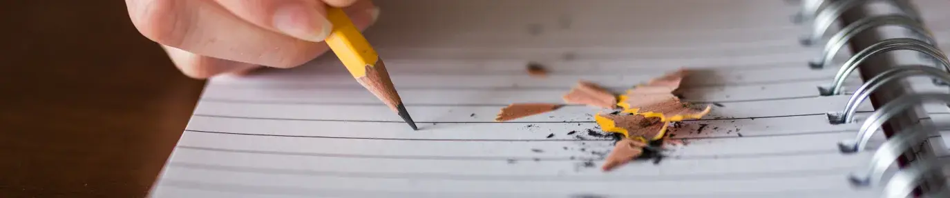 Person writing on a notebook