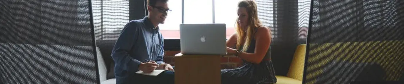woman and man looking at computer