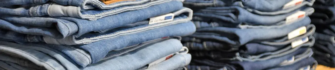 two stacks of light wash blue jeans