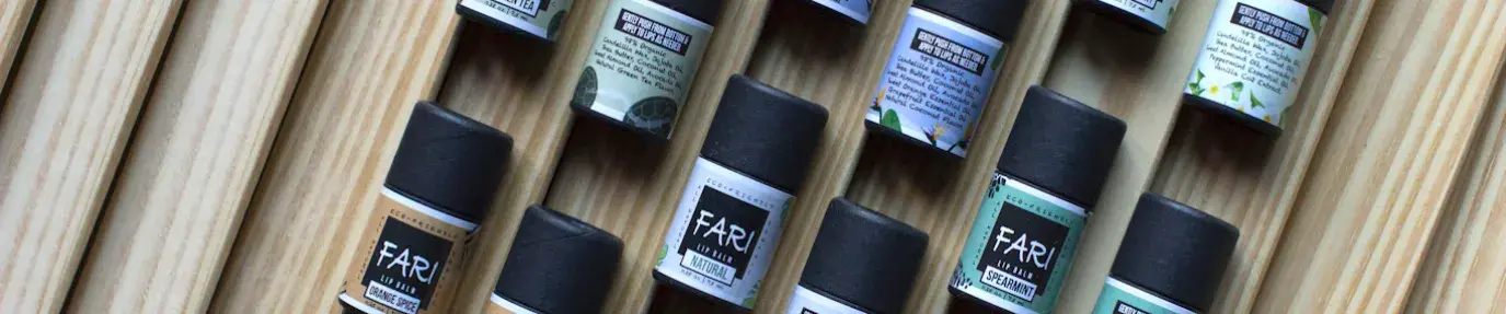 Several small bottles of products from FariOrganics, a Black woman-owned business, using compostable packaging