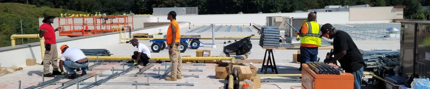 SUNS workers installing solar panels
