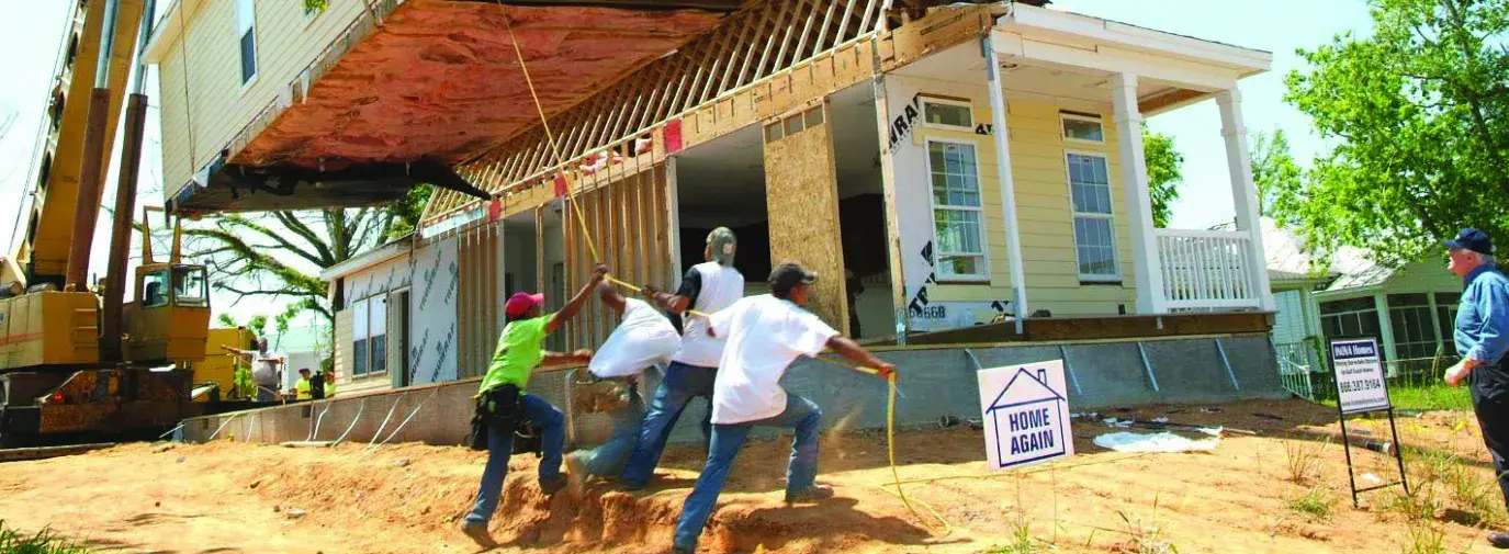 Image: home being lowered onto foundation. Topic: High Impact Community Investing