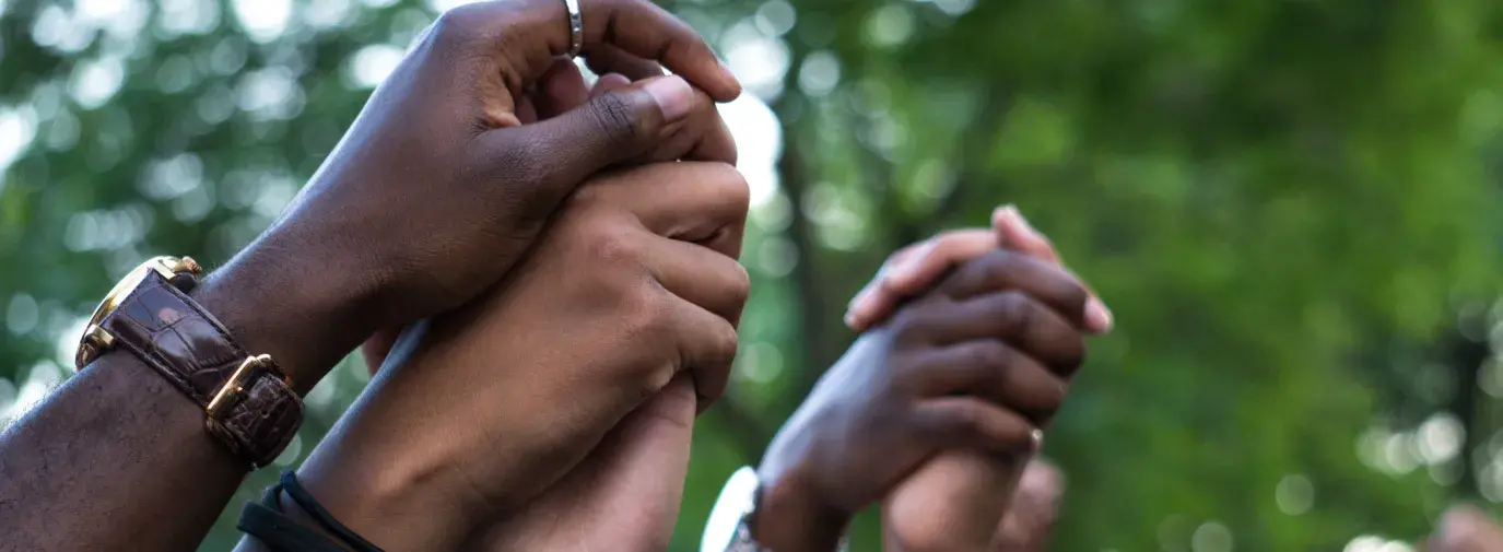 Image: holding hands. Topic: People of Color Are on the Front Lines of the Climate Crisis