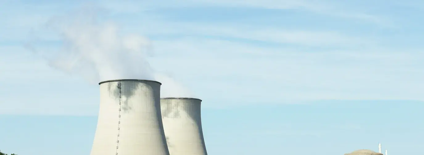 Image: nuclear energy plant smokestacks.
