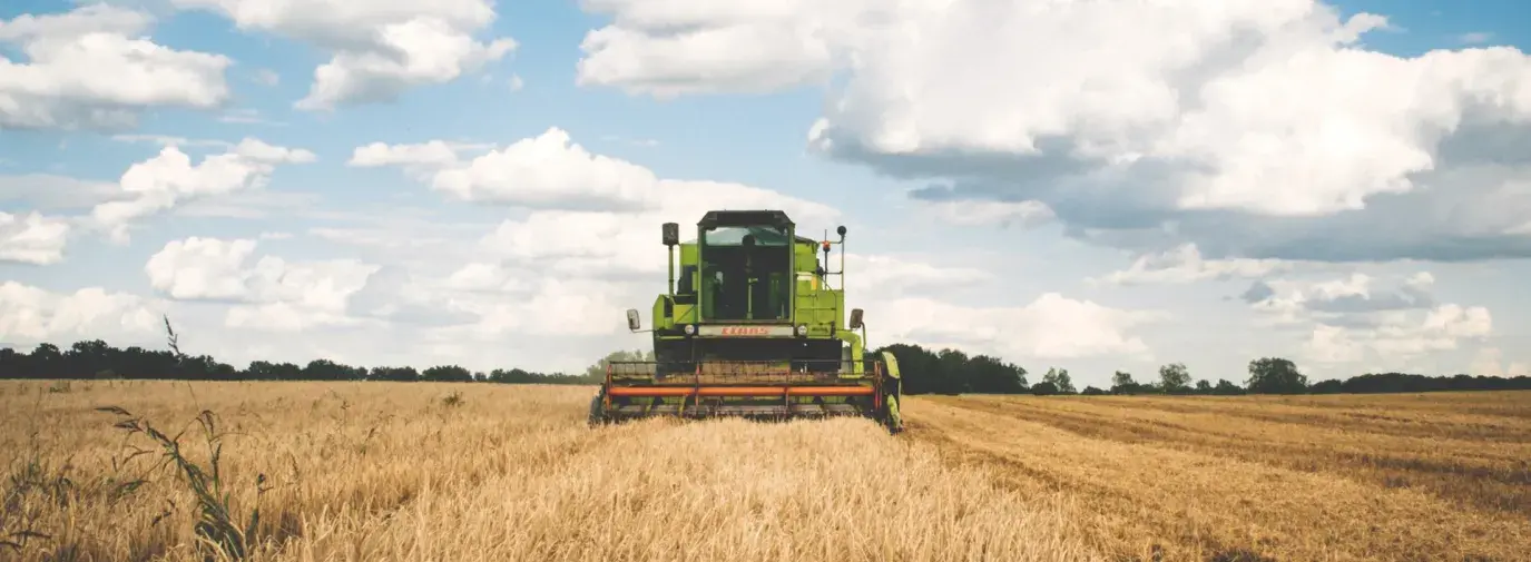 Image: wheat harvester in field. Topic: What is Carbon Farming?