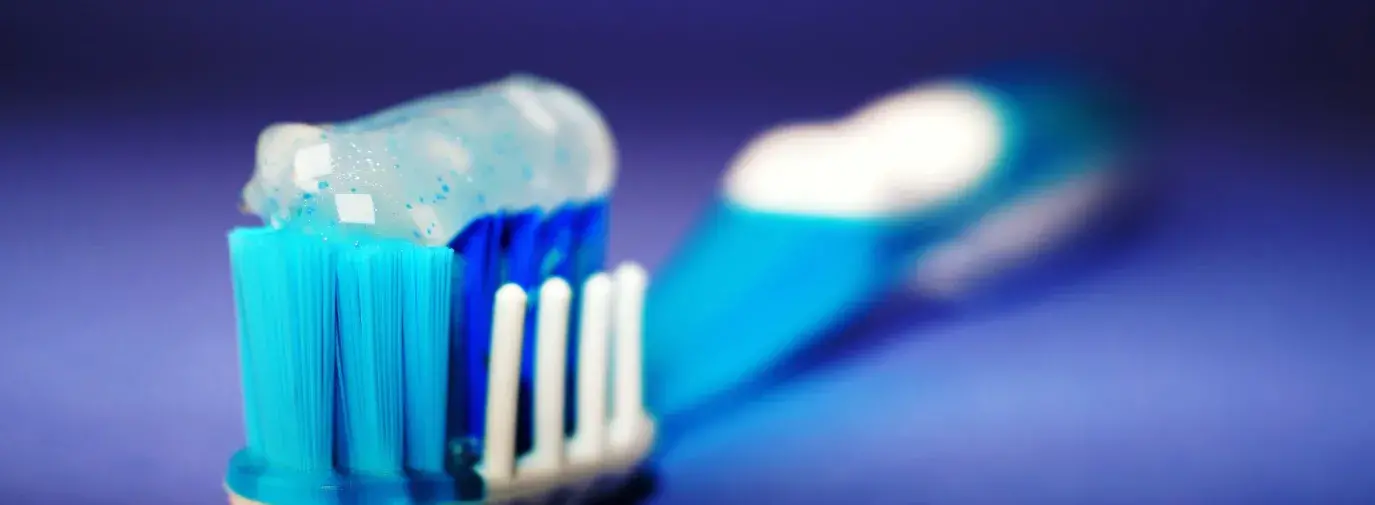 Image: toothbrush with toothpaste. Topic: Less-Toxic Dentistry: Silver Fillings and Other Concerns