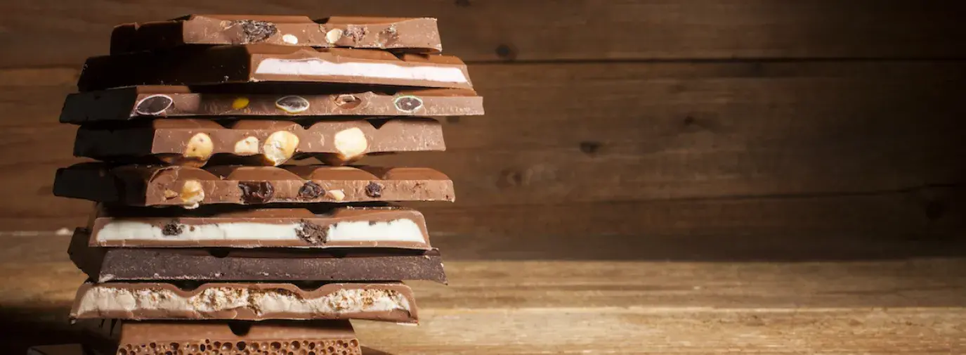 Image: stack of chocolate bars. Topic: Child Labor in Your Chocolate? Check Our Chocolate Scorecard