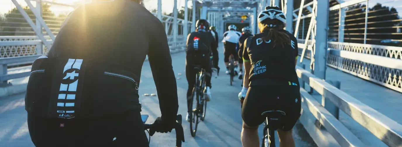 Image: people biking in performance clothing on a bridge. Topic: The Trouble with Nanoparticles in Clothing