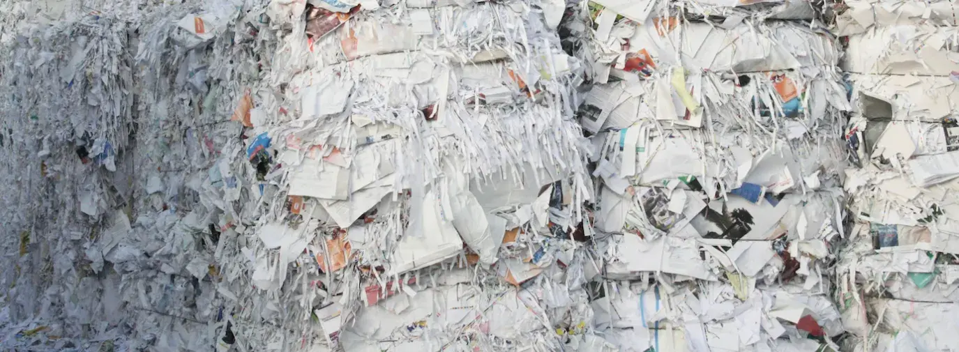 Image: huge bales of paper trash. Topic: Why Recycled Paper?
