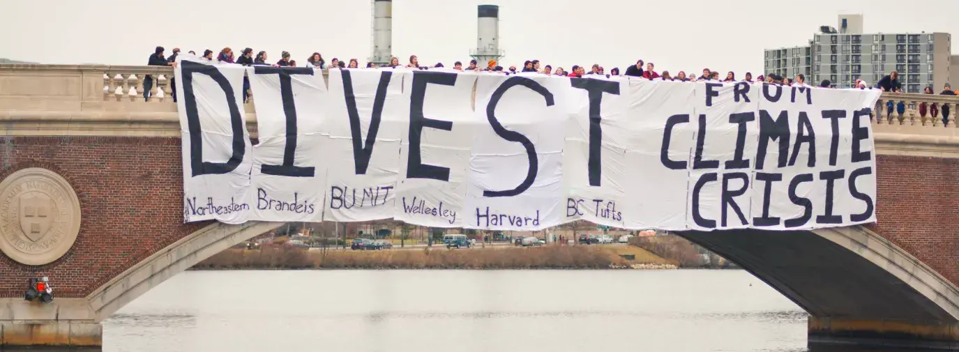 Boston-area university students gather for a joint banner drop over the Charles River to urge fossil fuel divestment.