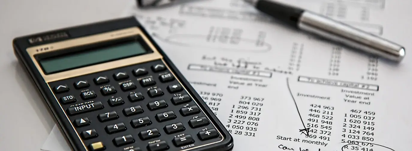 Image: calculator with financial ledger. Topic: The 5 Coolest Financial Calculators