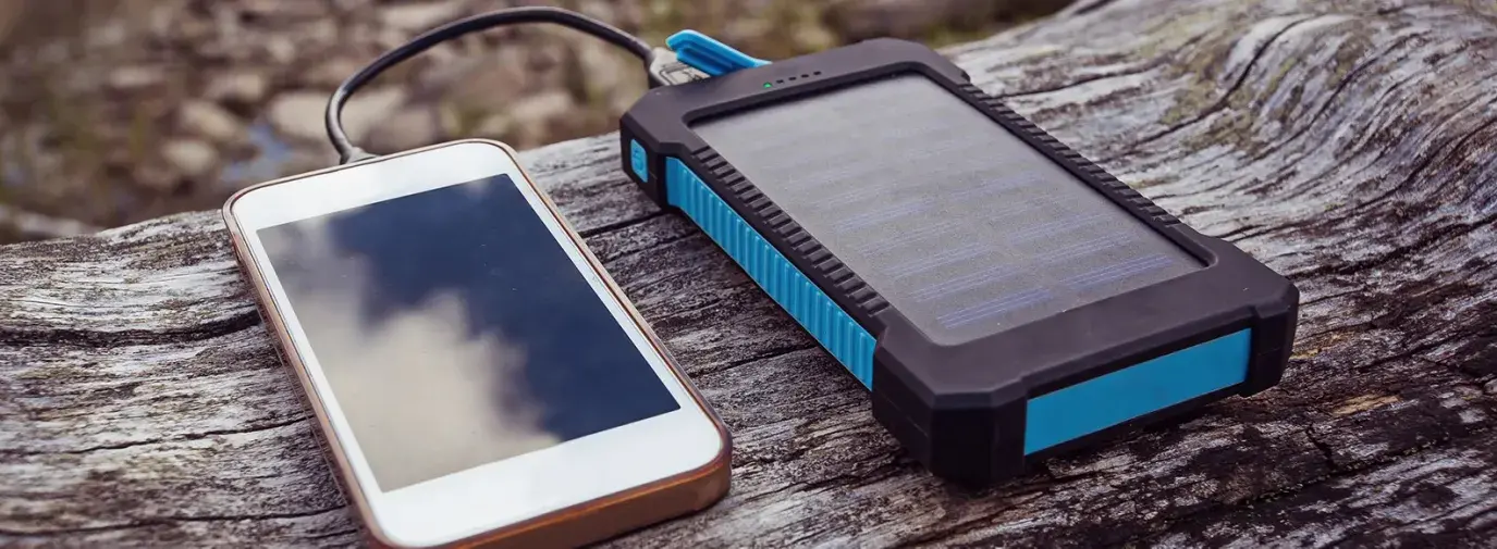 Image: phone being charged by small solar panel. Title: Find Renewable Energy Products for Less