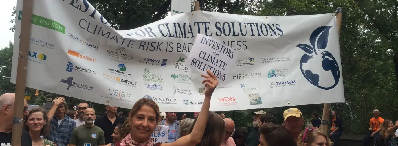 Shareholder activists from the Interfaith Center on Corporate Responsibility urge others to join them in addressing companies’ lack of action on global warming at the People’s Climate March in 2014. 