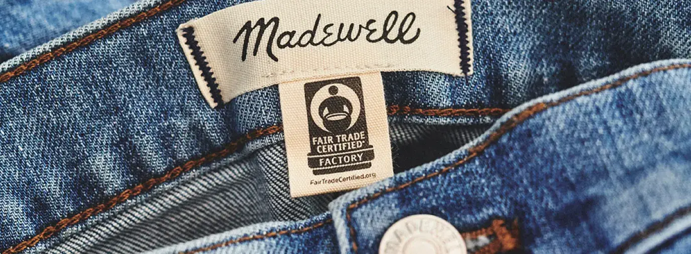 Image: close-up image of the fair trade tag on jeans. Topic: Are These Trends Green or Greenwashed?