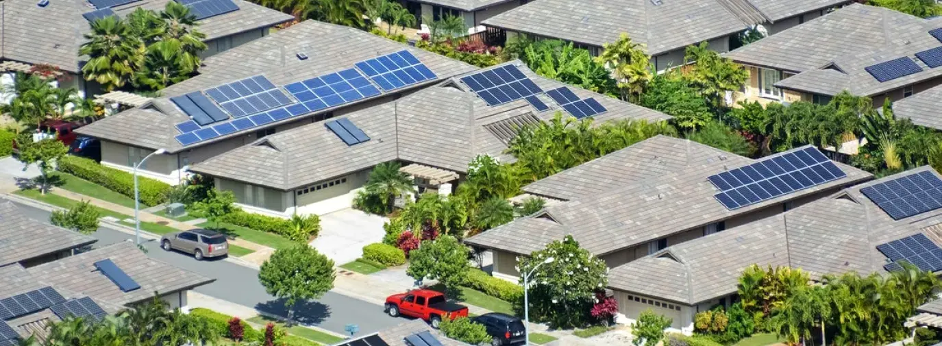 aerial view of homes with solar panels, financing solar panels is a big barrier