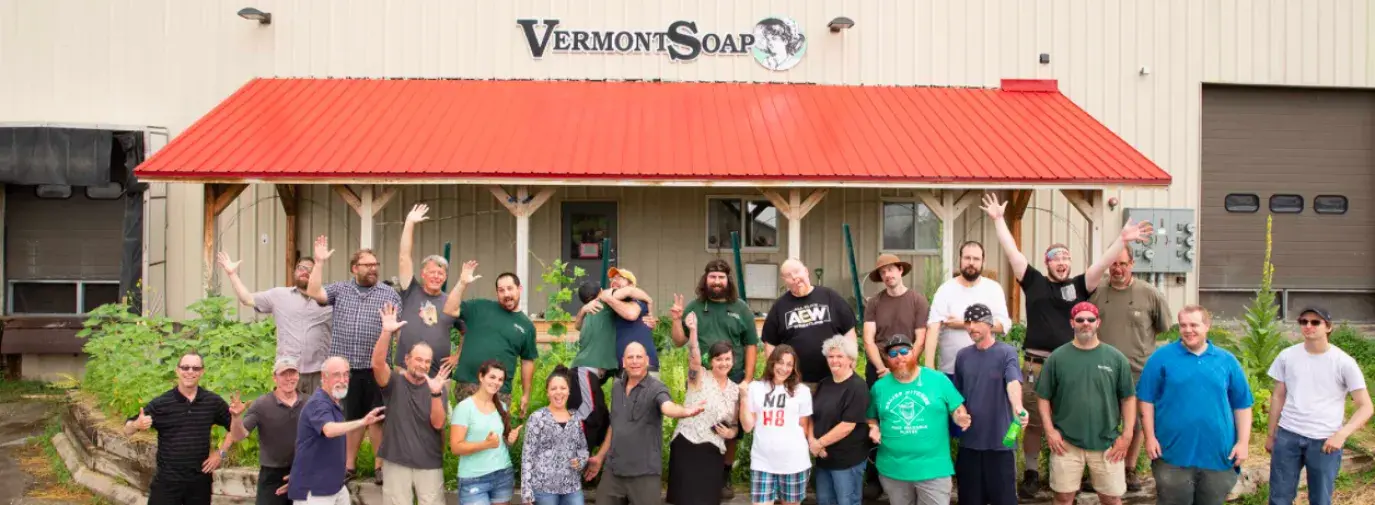 Group of individuals standing in front of a Vermont Soap factory