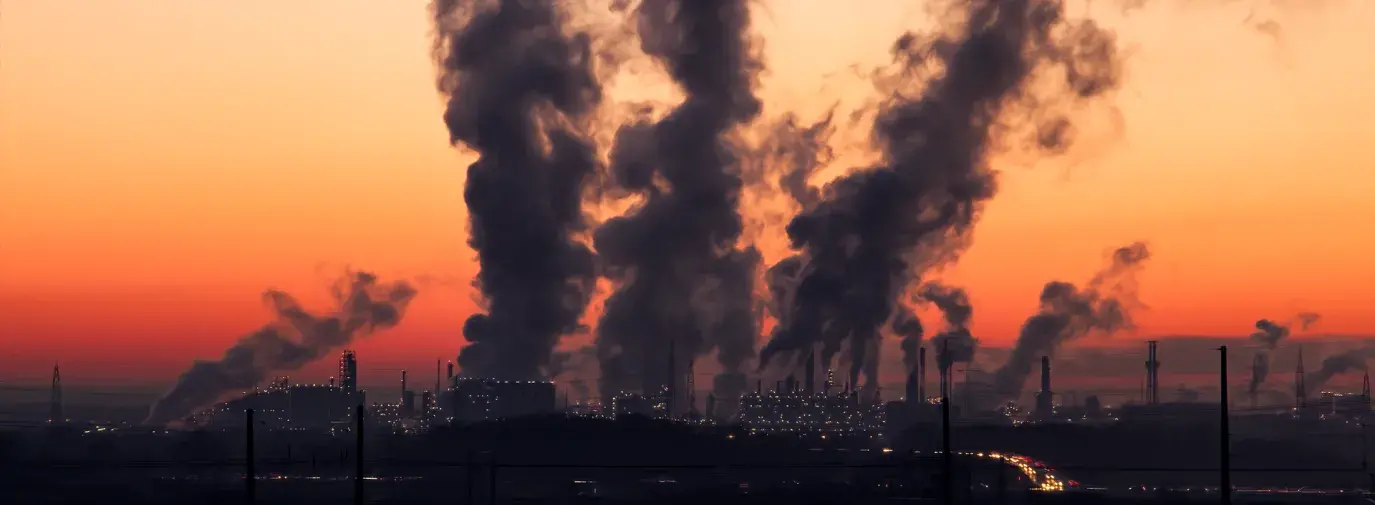 Image: coal plant emitting smoke Topic: Environmental Justice, fossil fuels, and telecoms