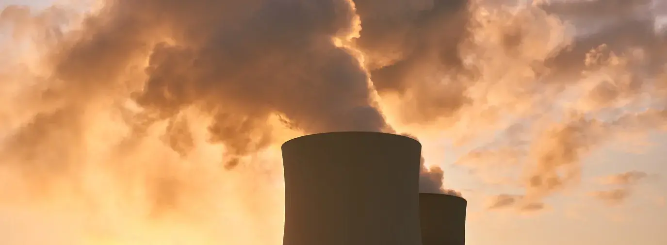 Image: two nuclear power plant stacks. Topic: Nuclear Power is Not a Climate Solution