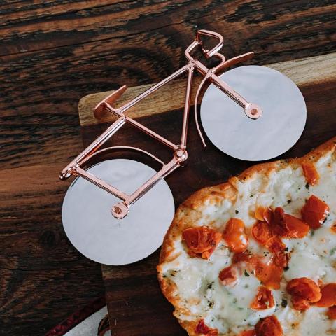 Pizza cutter in the shape of a bike. Fair Trade Gift Guide.