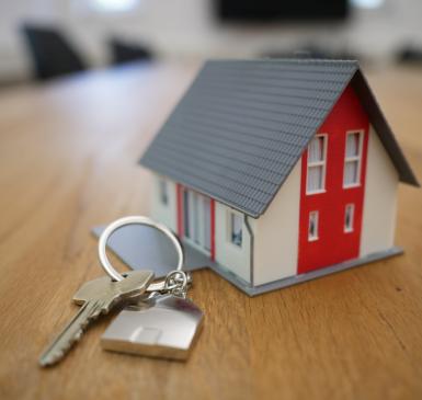 white and red wooden house on keychain