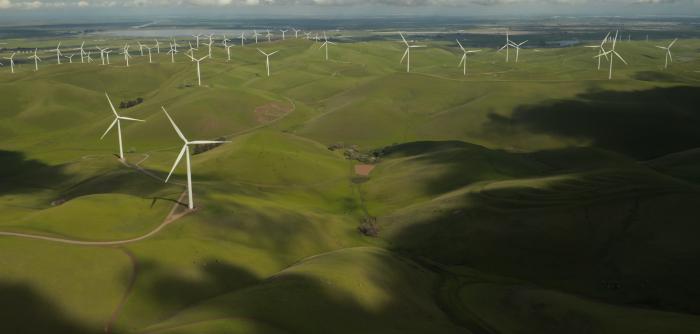 Image: wind turbines on green hills. Title: Clean Energy Victory Bonds