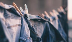 Image: Jeans hanging on a clothesline. Topic: sweatshop-free clothing.