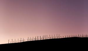 windmills on a hill at night