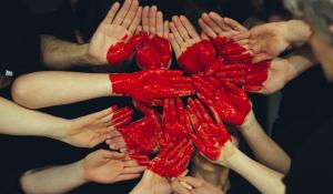 peoples hands together as a heart