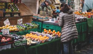 Image: street market with fruit and vegetables. Article: Buying Local and Going Green