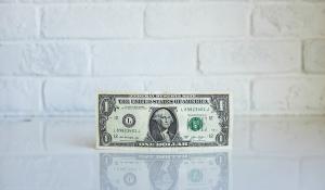 Image: one dollar bill. Topic: How a $25 Small Loan Can Change the World 