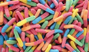 Image: colorful gummy worms. Title: The Sweet Side of Fair Trade 