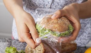 woman wraps sandwich in plastic
